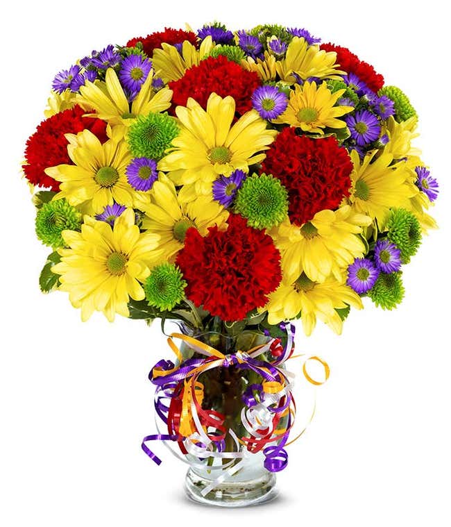 Yellow daisies, red carnations and green button pops in a glass vase