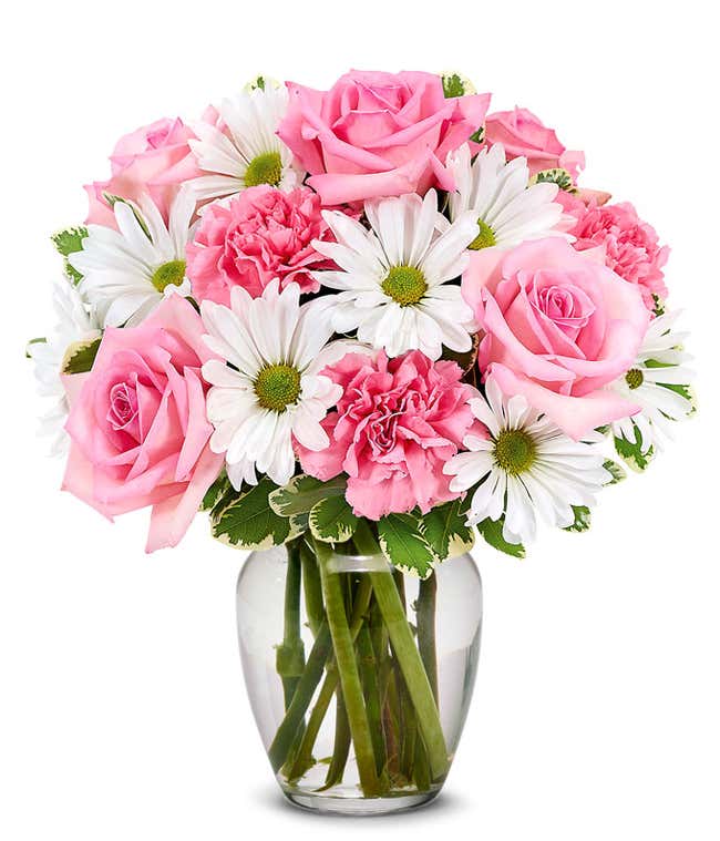 Pink roses, pink carnations and white daisies in a pink vase